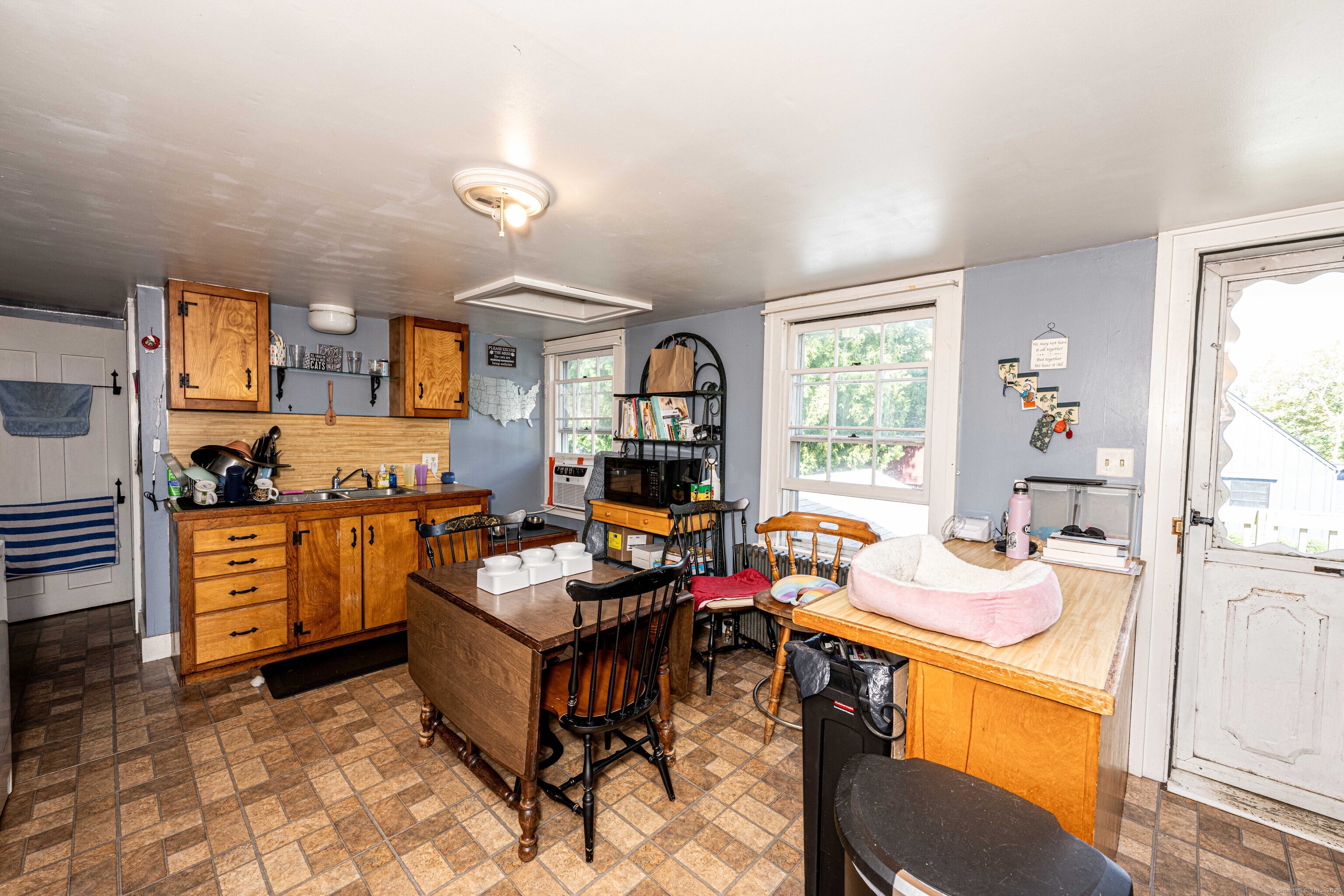 174 Whitfield Street Guilford, CT 06437 - Photo 22 of 40 a room with furniture a flat screen tv and a window