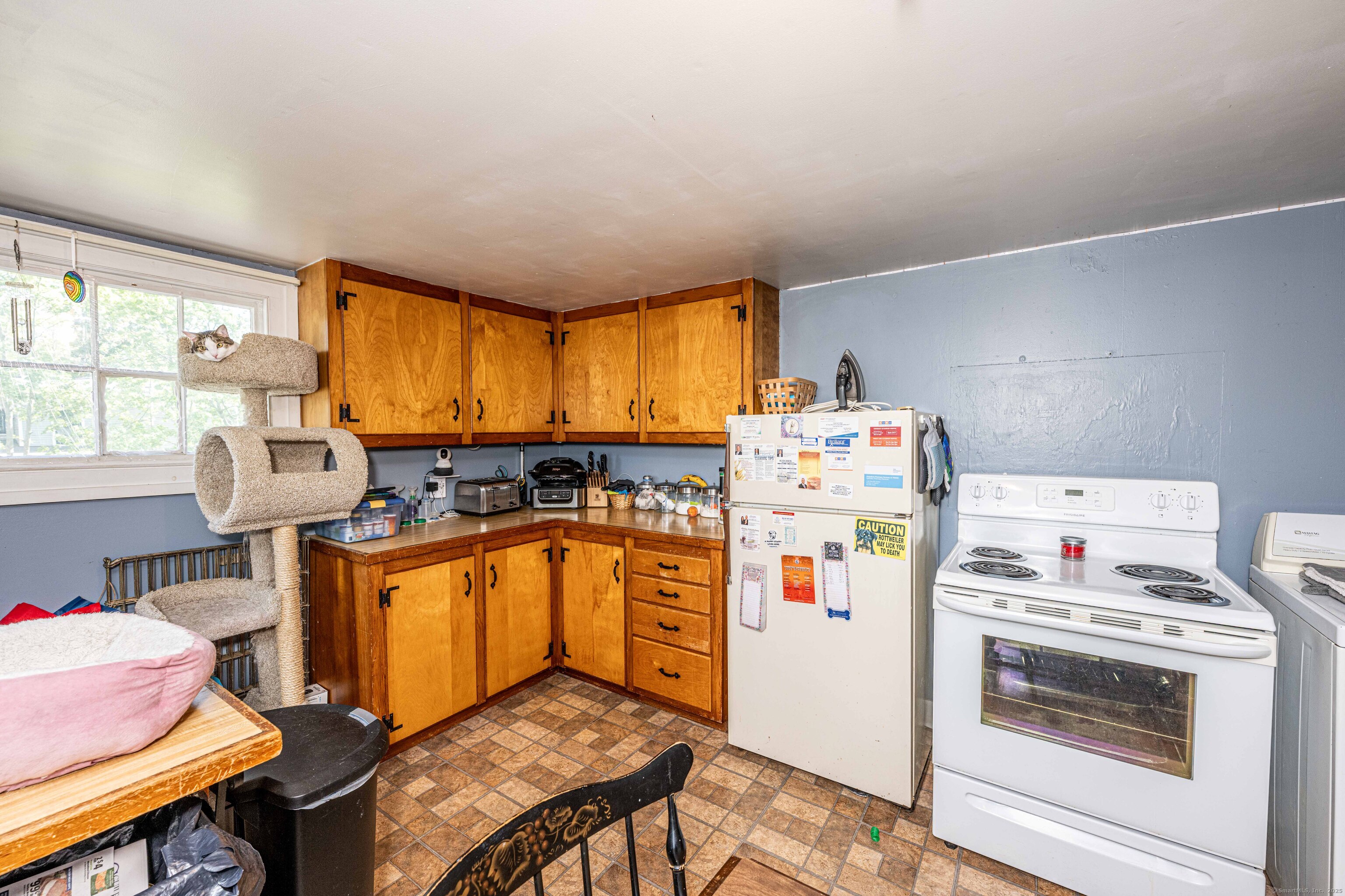 174 Whitfield Street Guilford, CT 06437 - Photo 23 of 40 a kitchen with a refrigerator and a stove top oven