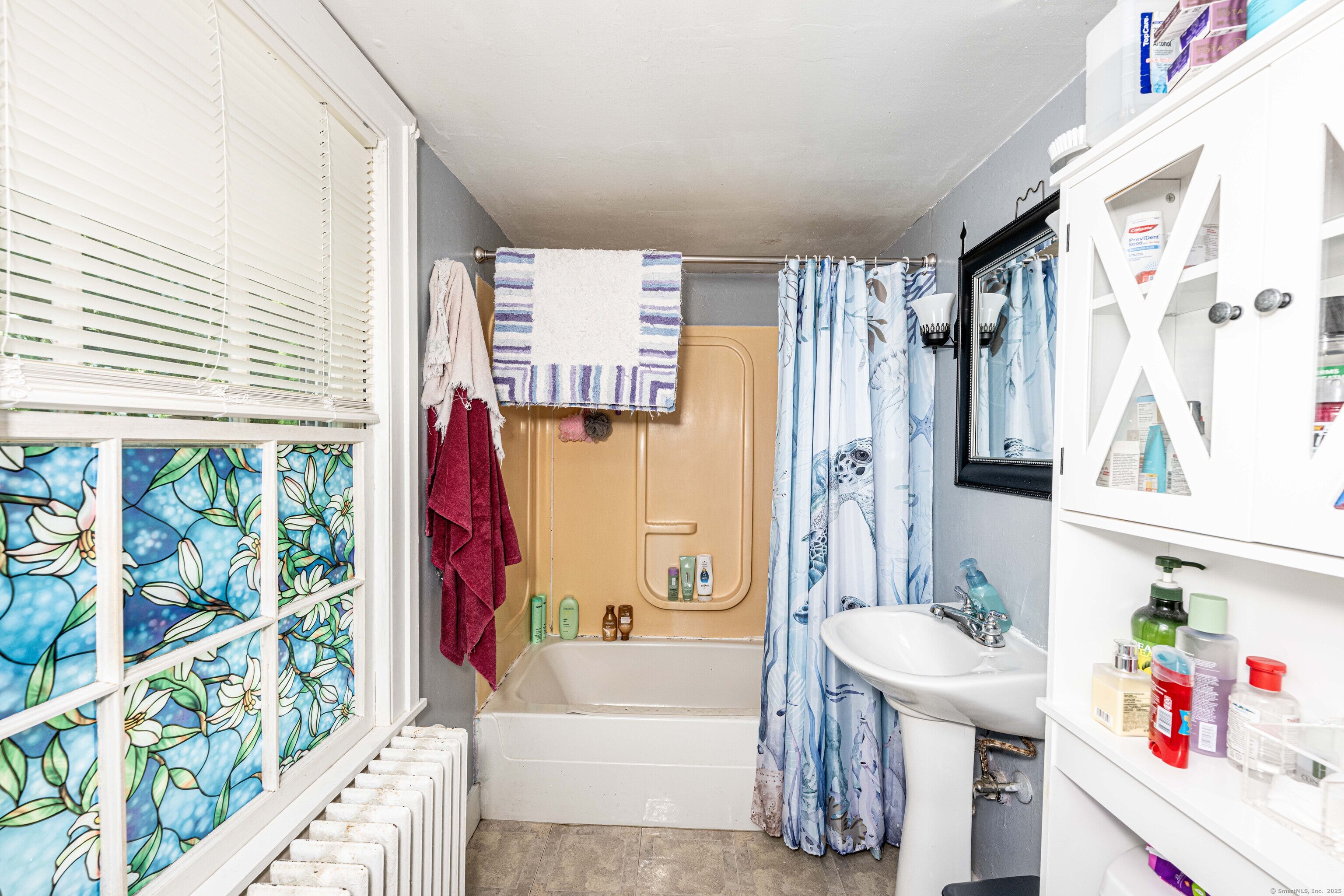 174 Whitfield Street Guilford, CT 06437 - Photo 26 of 40 a bathroom with a tub sink and a large mirror