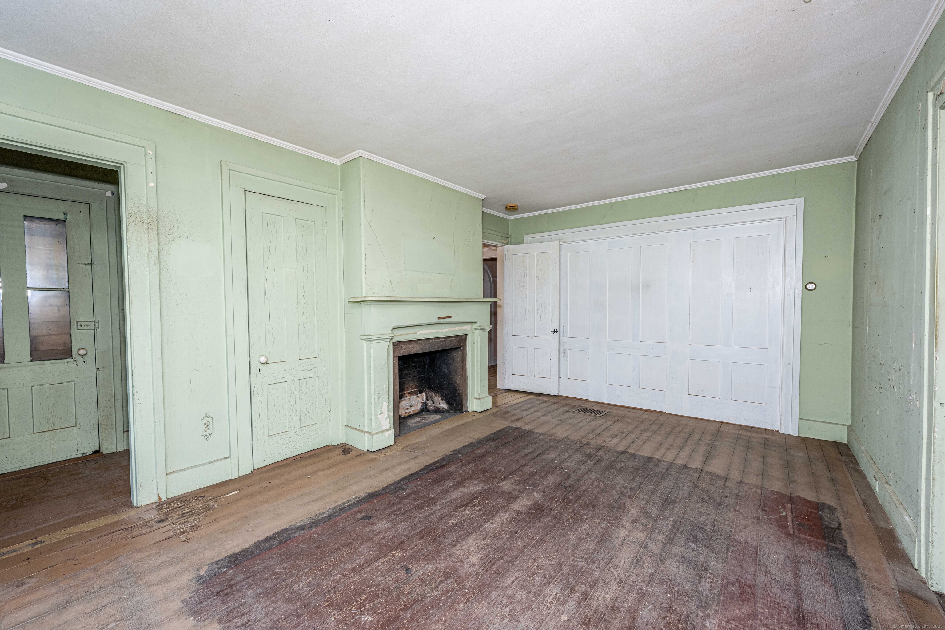 174 Whitfield Street Guilford, CT 06437 - Photo 31 of 40 a view of empty room with wooden floor and fireplace