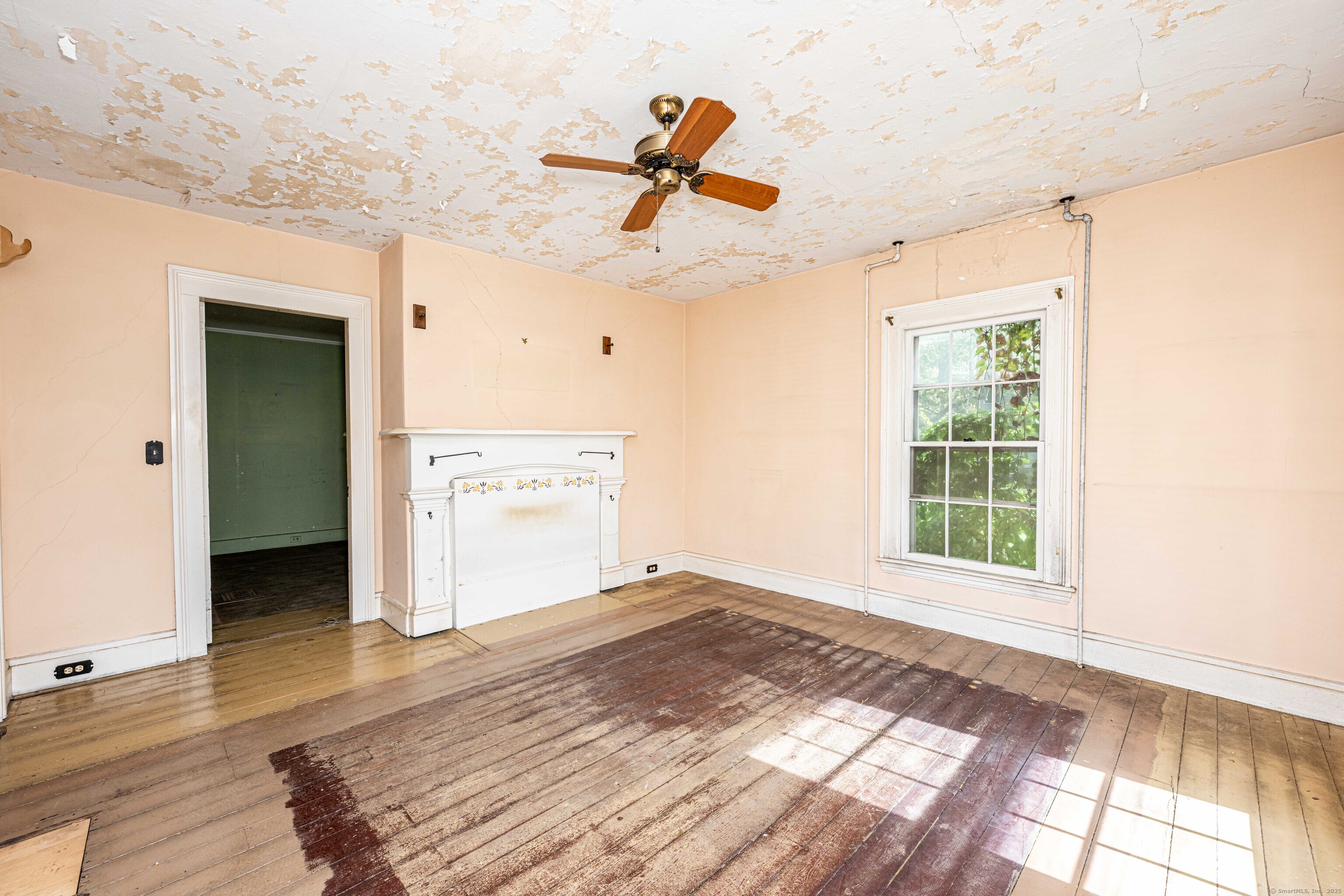 174 Whitfield Street Guilford, CT 06437 - Photo 33 of 40 a view of empty room with wooden floor and fan