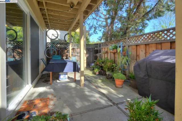 a view of a porch with chairs and potted plants