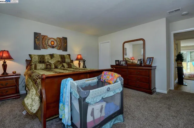 a living room with furniture and a dresser