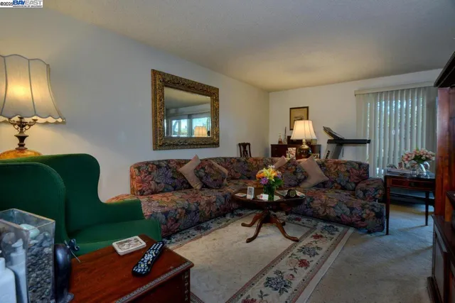 a living room with furniture and a lamp