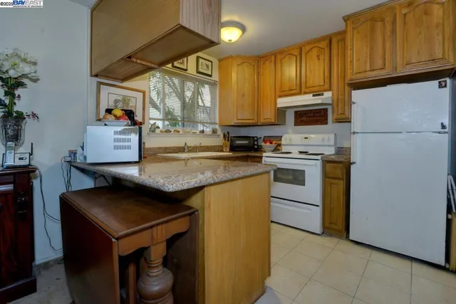a kitchen with stainless steel appliances a stove sink microwave and cabinets