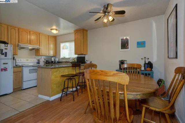 a dining room with stainless steel appliances kitchen island granite countertop furniture and a kitchen view