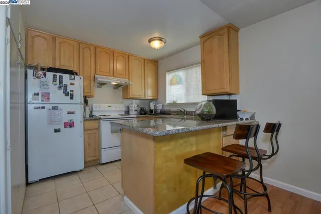 a kitchen with a refrigerator and cabinets
