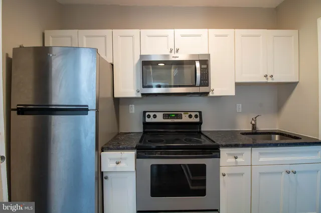 a kitchen with cabinets and stainless steel appliances