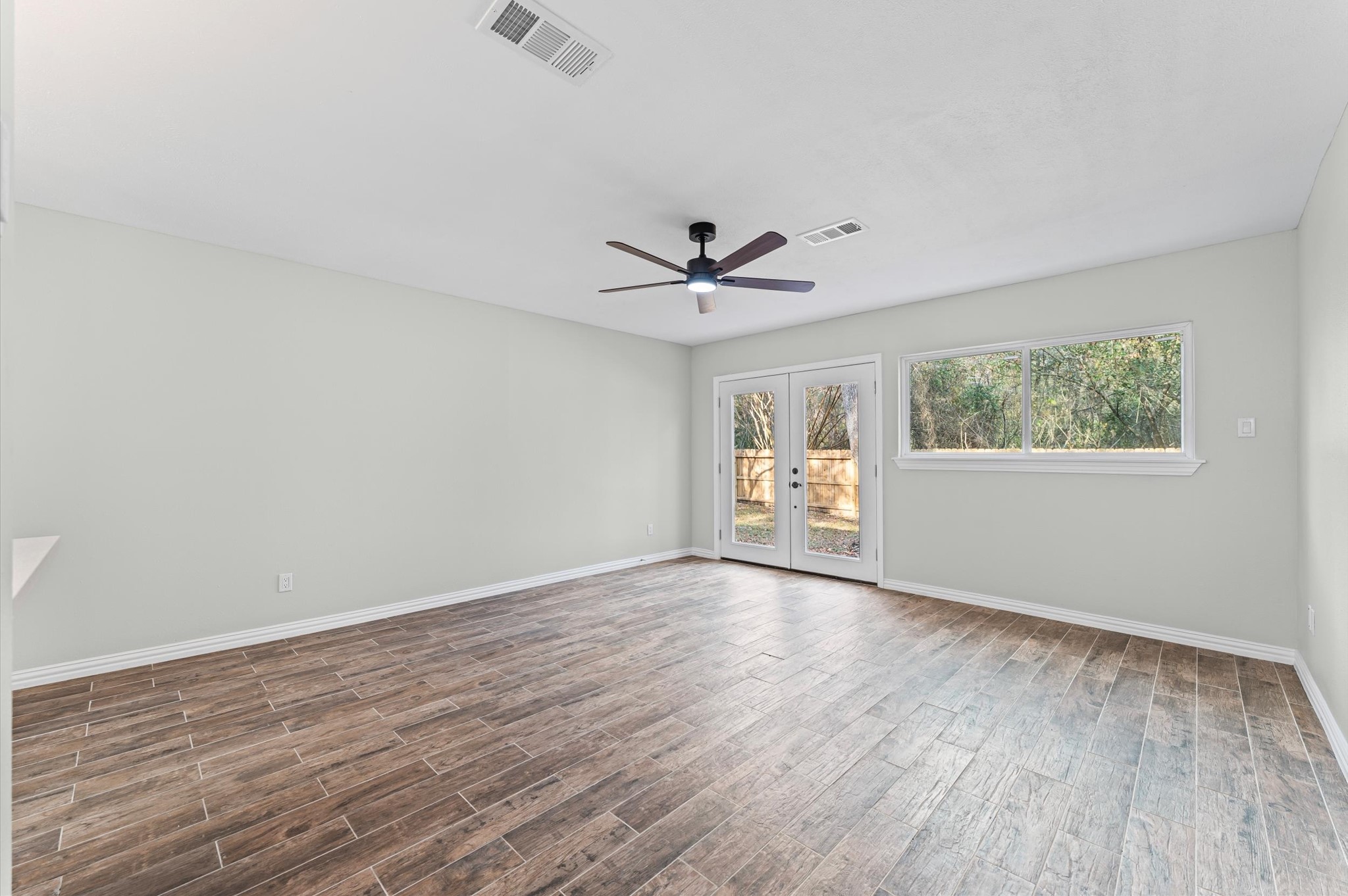 1808 North Red Cedar Circle Spring, TX 77380 - Photo 17 of 31 wooden floor in an empty room with a window