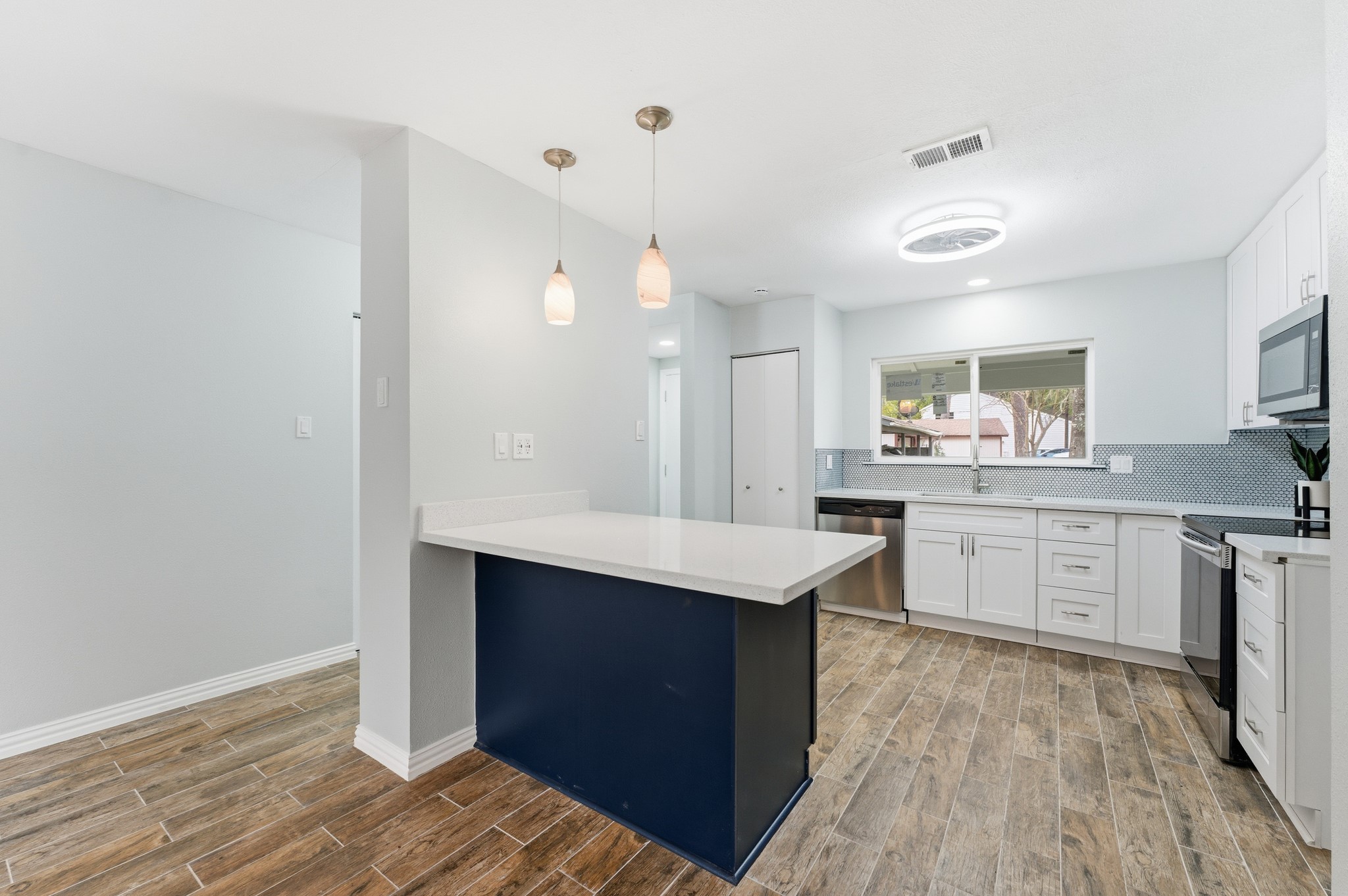 1808 North Red Cedar Circle Spring, TX 77380 - Photo 9 of 31 a kitchen with granite countertop a sink cabinets and wooden floor