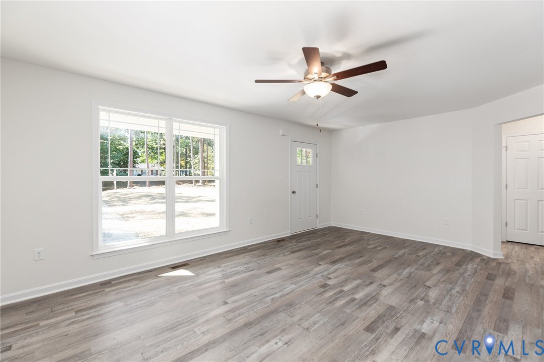 69 Pinewood Lane Colonial Beach, VA 22443 - Photo 2 of 20 Unfurnished living room with light wood-style floo