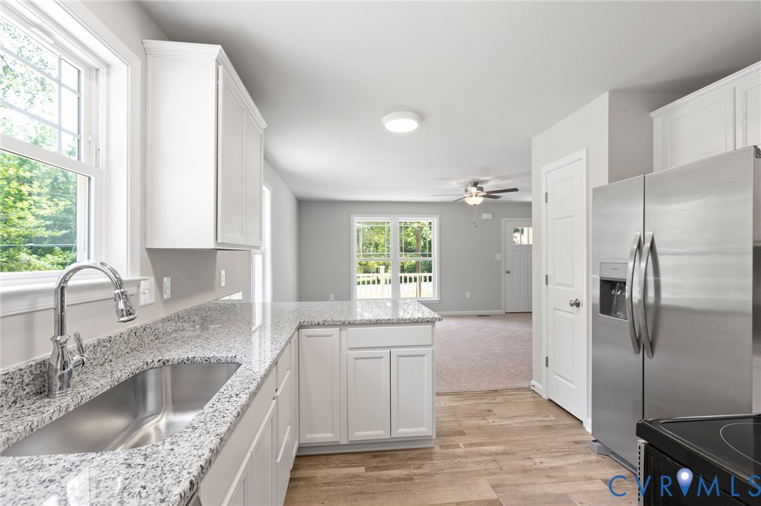 69 Pinewood Lane Colonial Beach, VA 22443 - Photo 3 of 20 Kitchen featuring stainless steel fridge, white ca