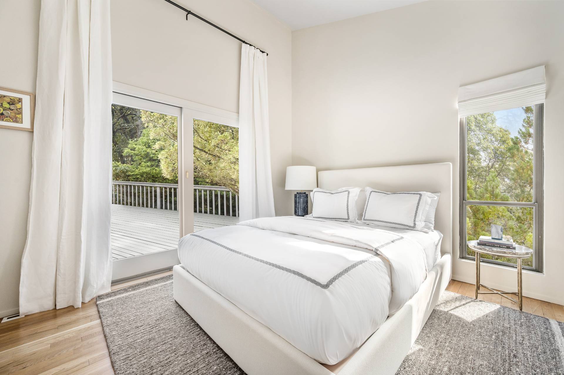 12 Rivers Road East Hampton, NY 11937 - Photo 20 of 23 a large white bed sitting in a bedroom next to a window