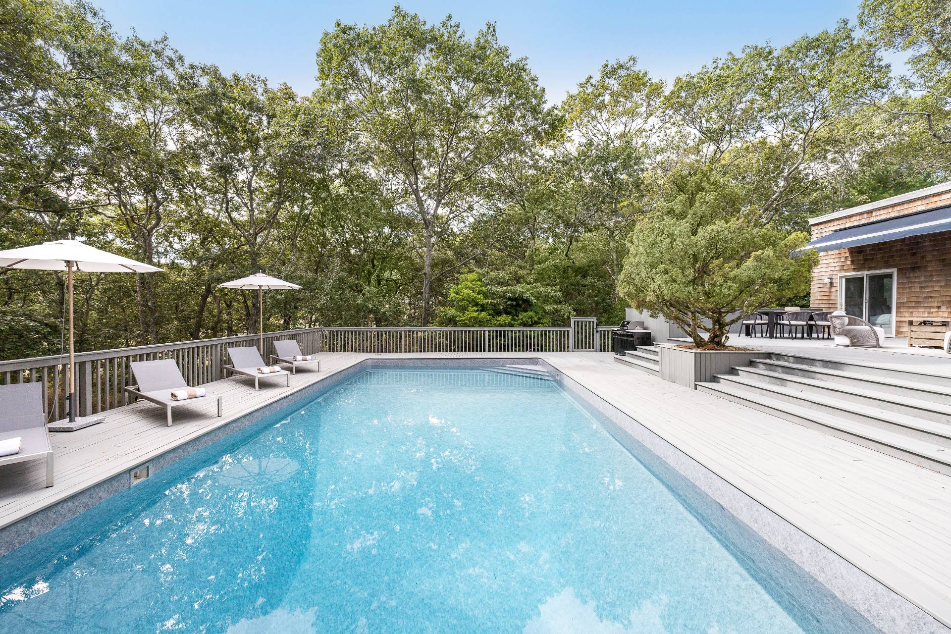 12 Rivers Road East Hampton, NY 11937 - Photo 2 of 23 a view of a swimming pool with a patio