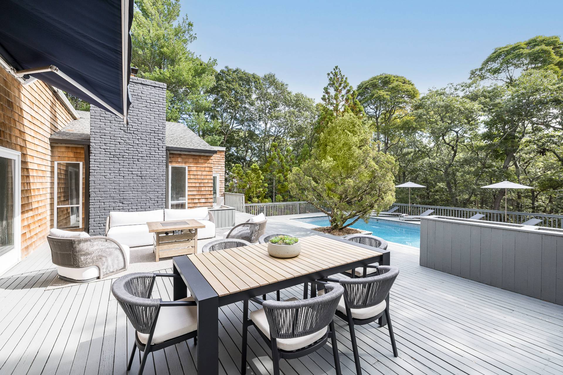 12 Rivers Road East Hampton, NY 11937 - Photo 4 of 23 a view of a patio with a dining table and chairs with wooden floor