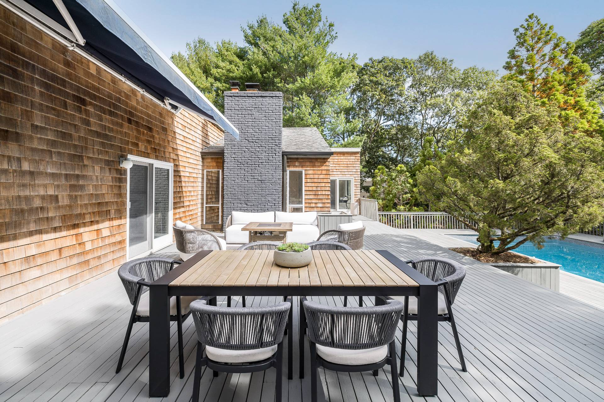 12 Rivers Road East Hampton, NY 11937 - Photo 5 of 23 a patio with table and chairs and potted plants