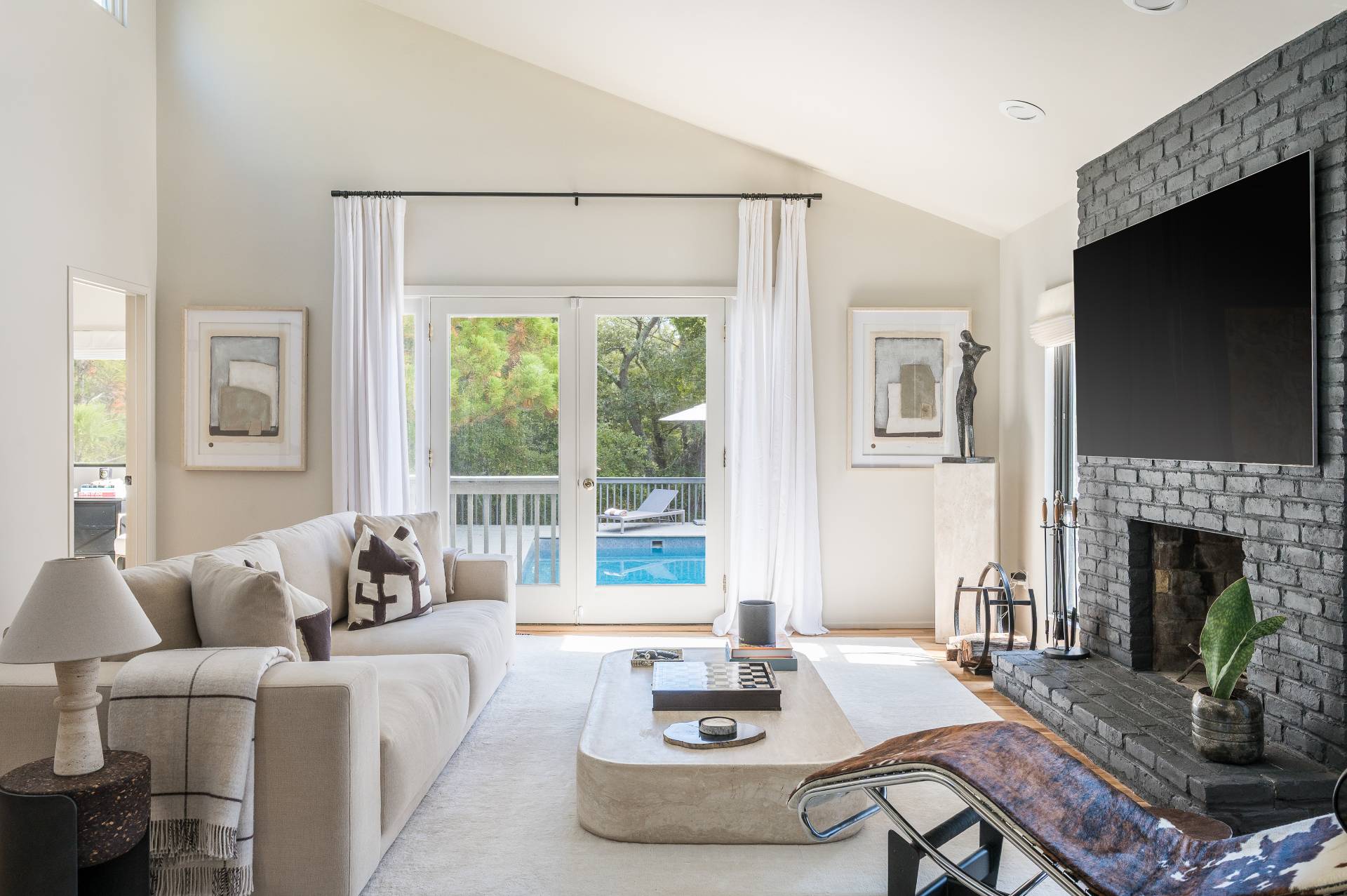 12 Rivers Road East Hampton, NY 11937 - Photo 9 of 23 a living room with furniture a fireplace and a flat screen tv