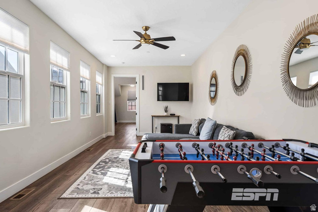 4311 Canterbury Road, Unit F2 Hurricane, UT 84737 - Photo 11 of 18 Spacious recreational room featuring wood-finish flooring, a ceiling fan, recessed lighting, and multiple windows with blinds