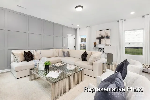 a living room with furniture and a painting