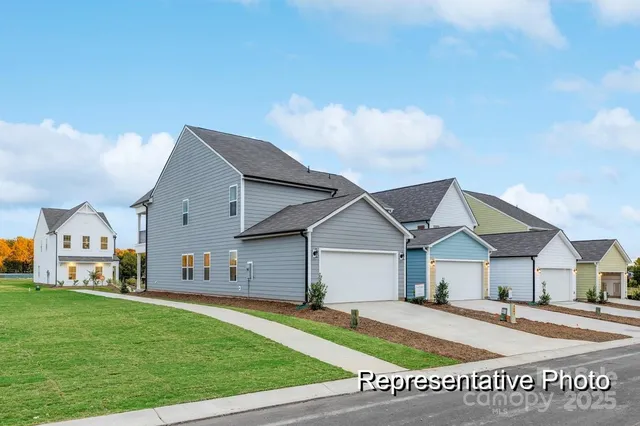 a front view of a house with a garden and yard