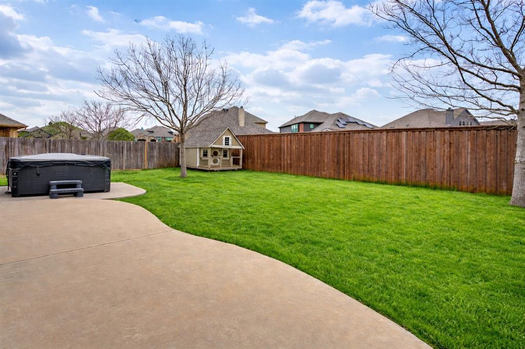1137 Cardinal Ridge Road Burleson, TX 76028 - Photo 28 of 28 Fenced backyard with an outbuilding, a hot tub, and a patio