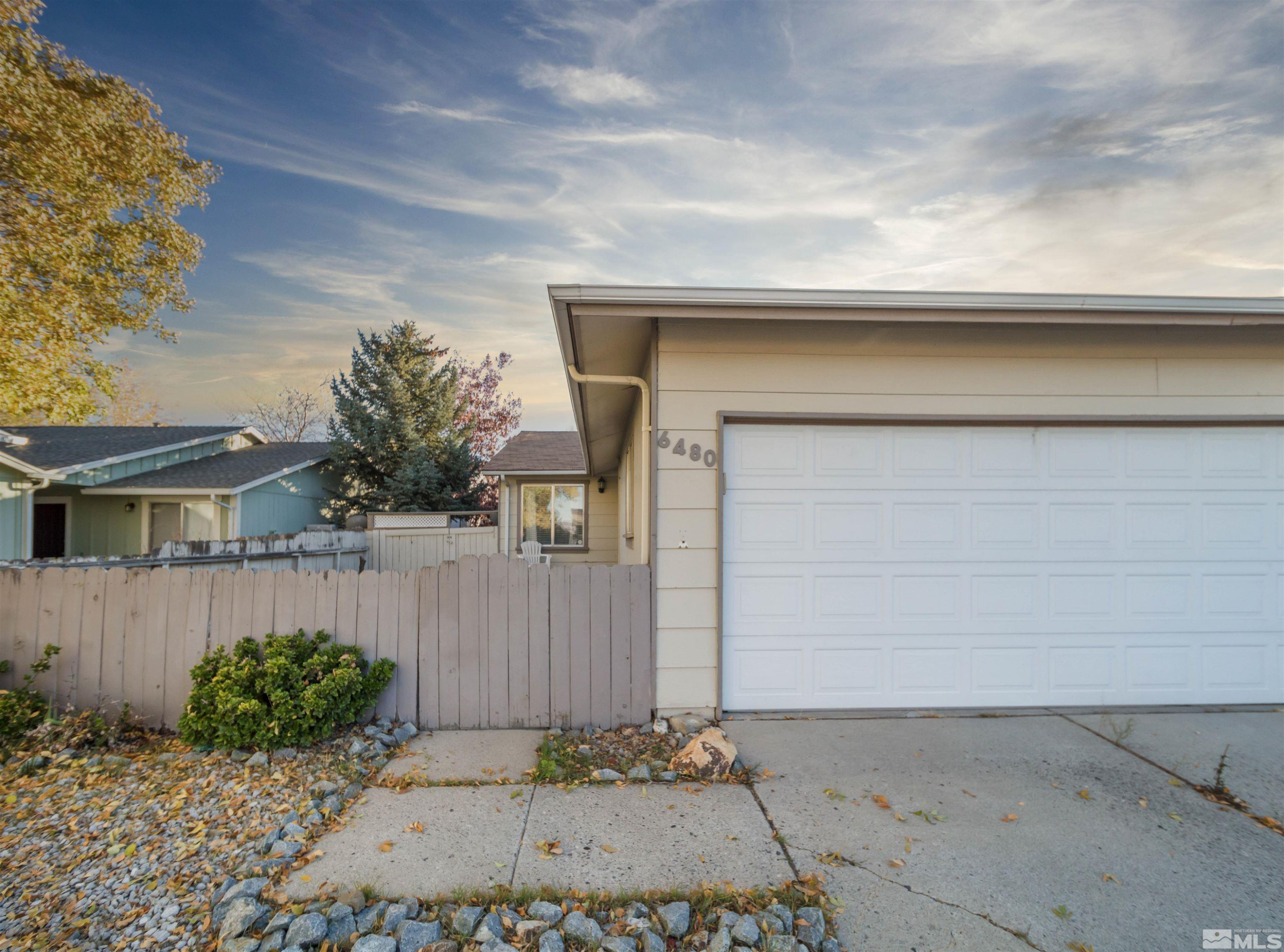 6480 Lotus Street Reno, NV 89506 - Photo 1 of 22 front view of a house with a garage