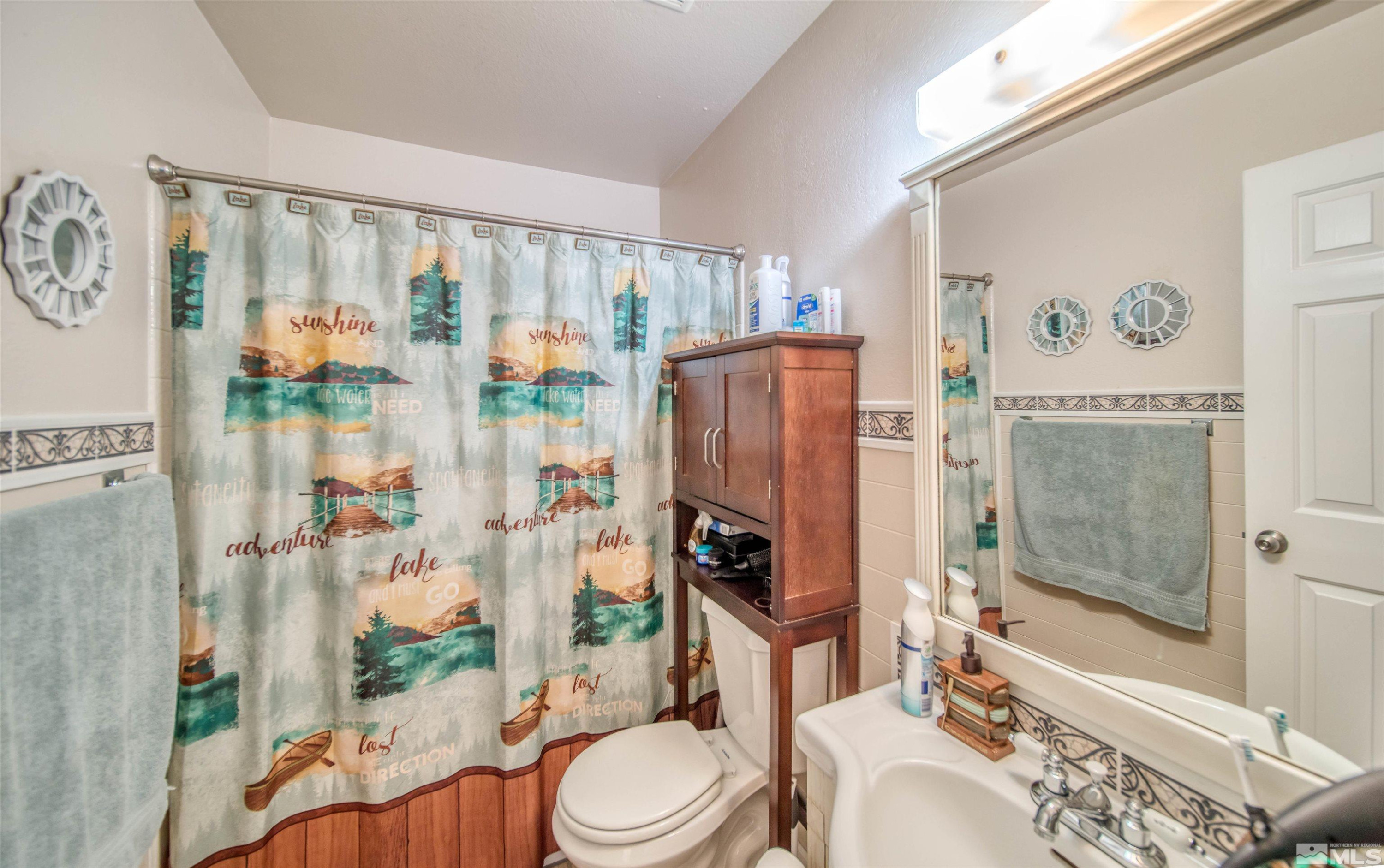 6480 Lotus Street Reno, NV 89506 - Photo 18 of 22 a bathroom with a toilet a sink and a shower