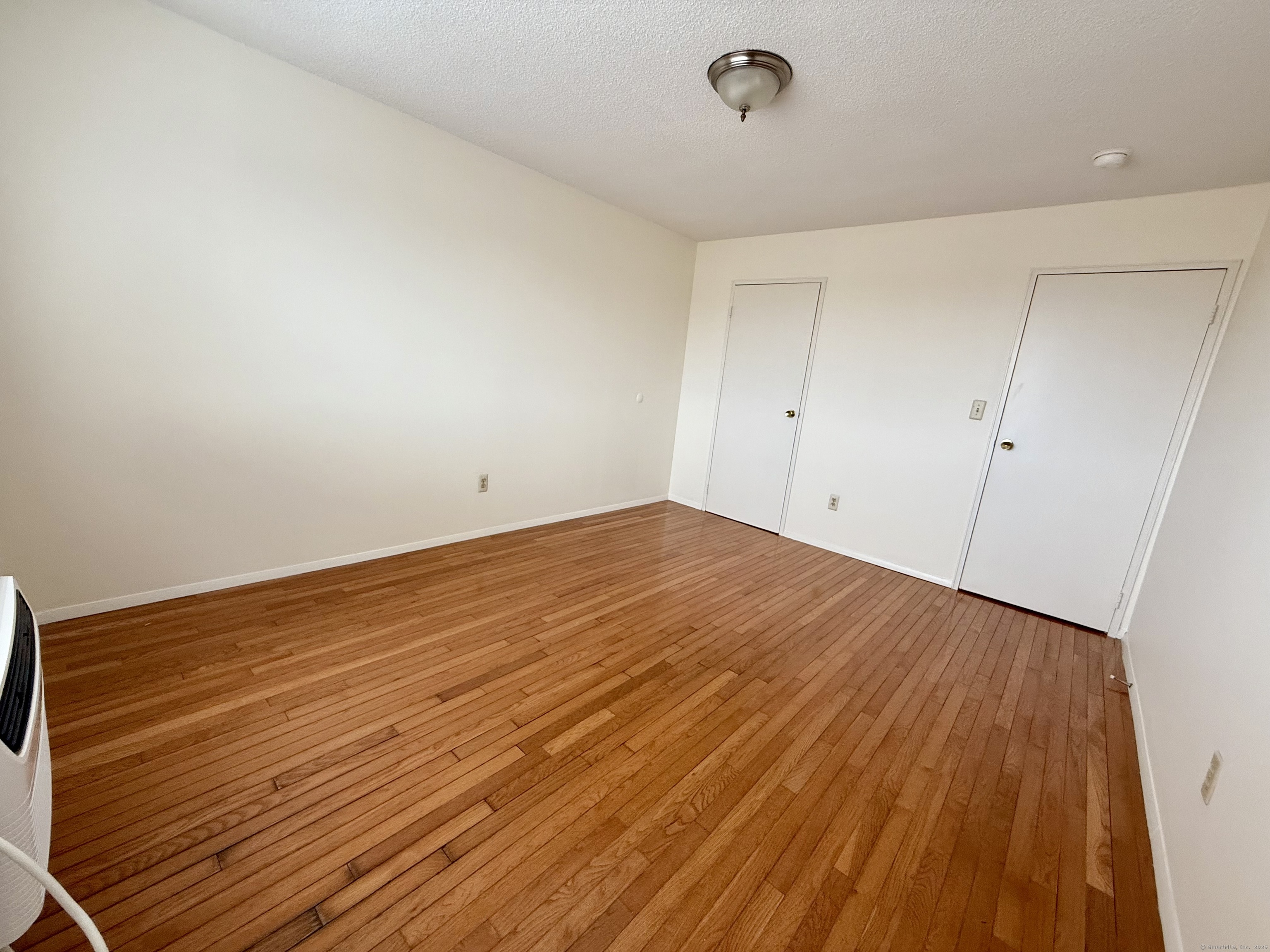 1168 Main Street, Unit C7 Stratford, CT 06615 - Photo 4 of 12 a view of empty room with wooden floor