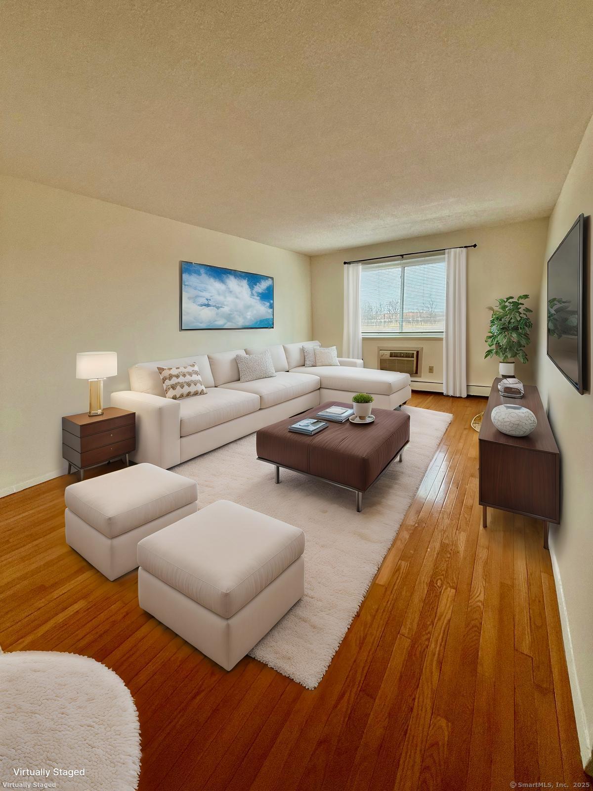 1168 Main Street, Unit C7 Stratford, CT 06615 - Photo 5 of 12 a living room with couches and a flat screen tv