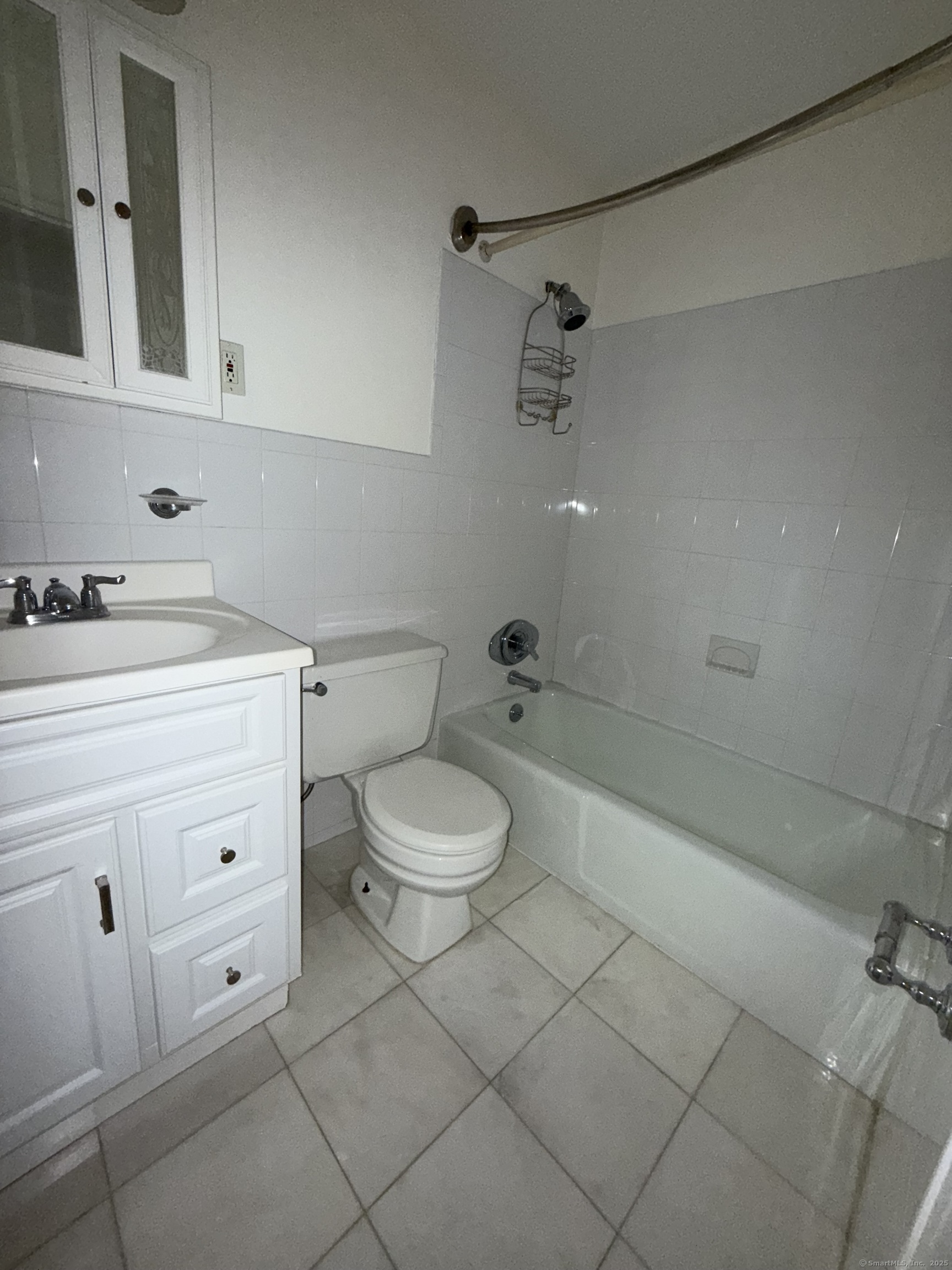 1168 Main Street, Unit C7 Stratford, CT 06615 - Photo 10 of 12 a bathroom with a toilet a sink a mirror and vanity
