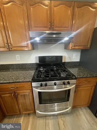 a stove top oven sitting inside of a kitchen
