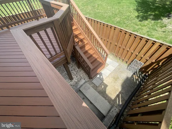 a backyard of a house with plants and wooden fence