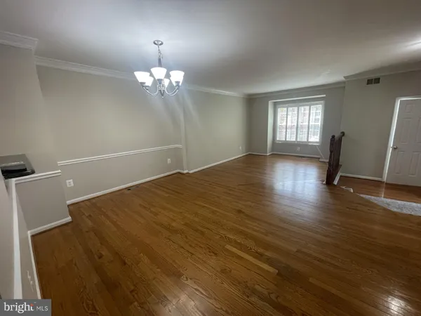 a view of wooden floor and windows in a room