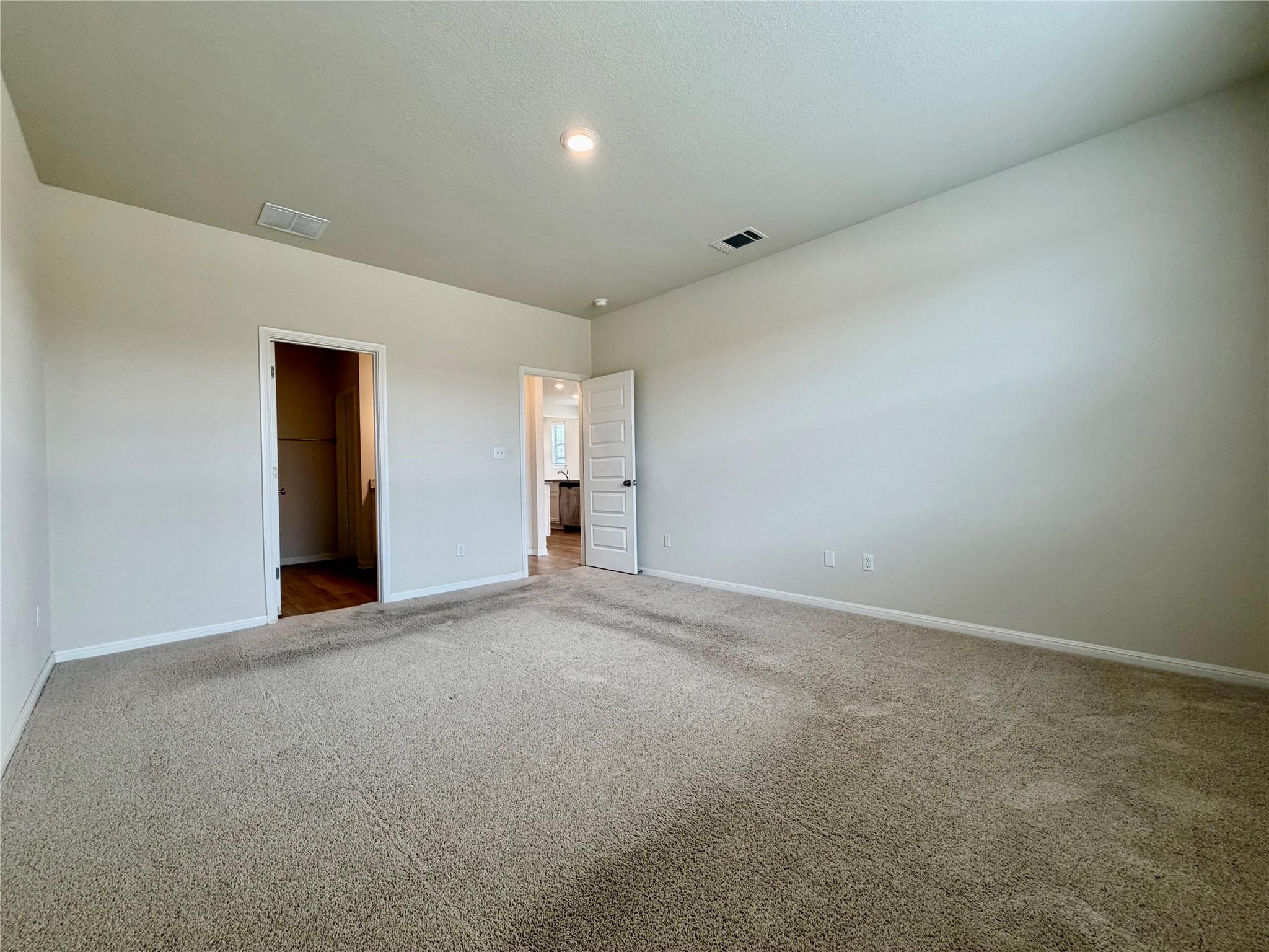 305 Tolo Drive Elgin, TX 78621 - Photo 13 of 27 Spacious carpeted room featuring light-colored walls, a recessed ceiling light, and white trim