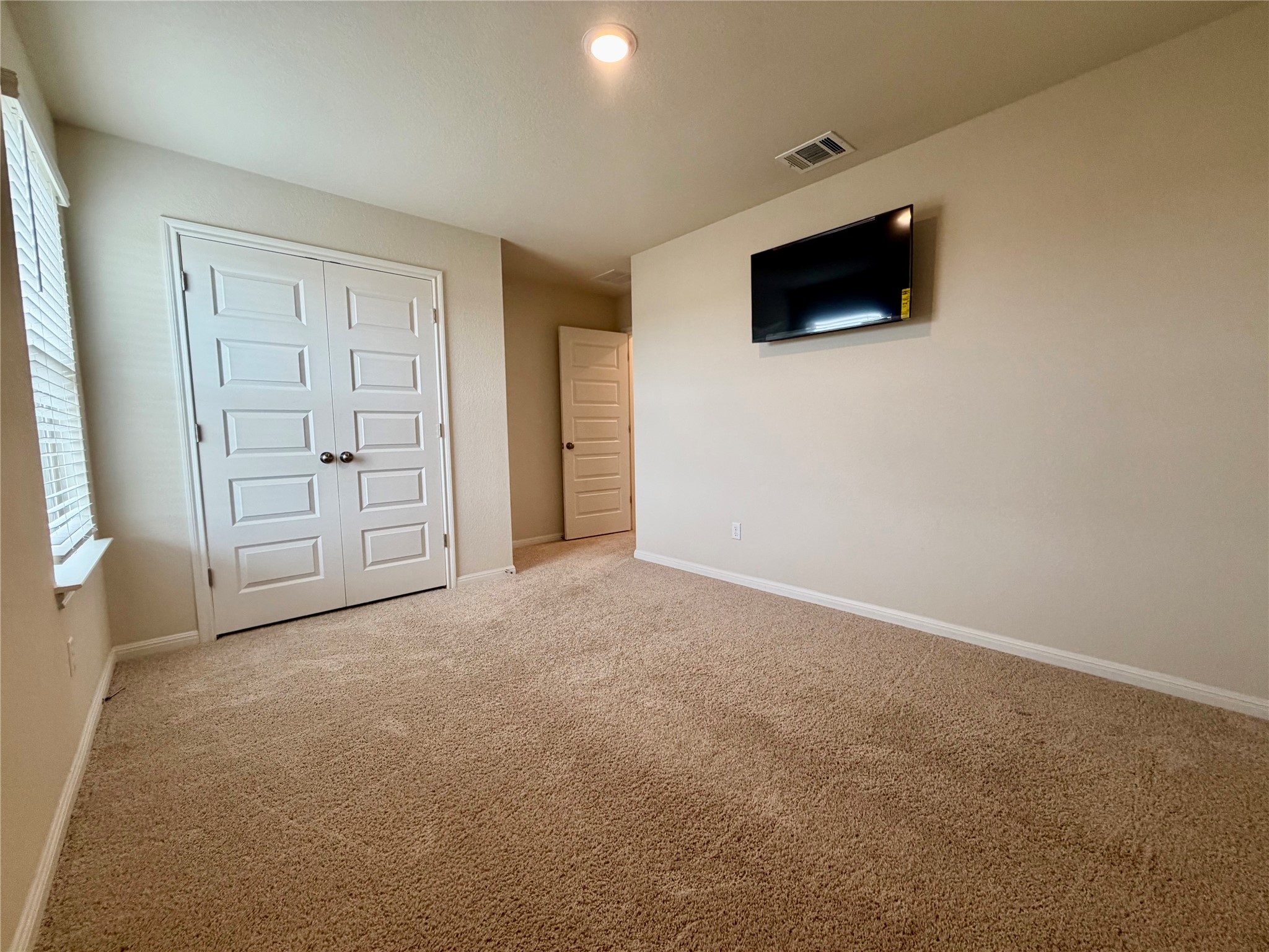 305 Tolo Drive Elgin, TX 78621 - Photo 22 of 27 Neutral-toned wall-to-wall carpeting throughout