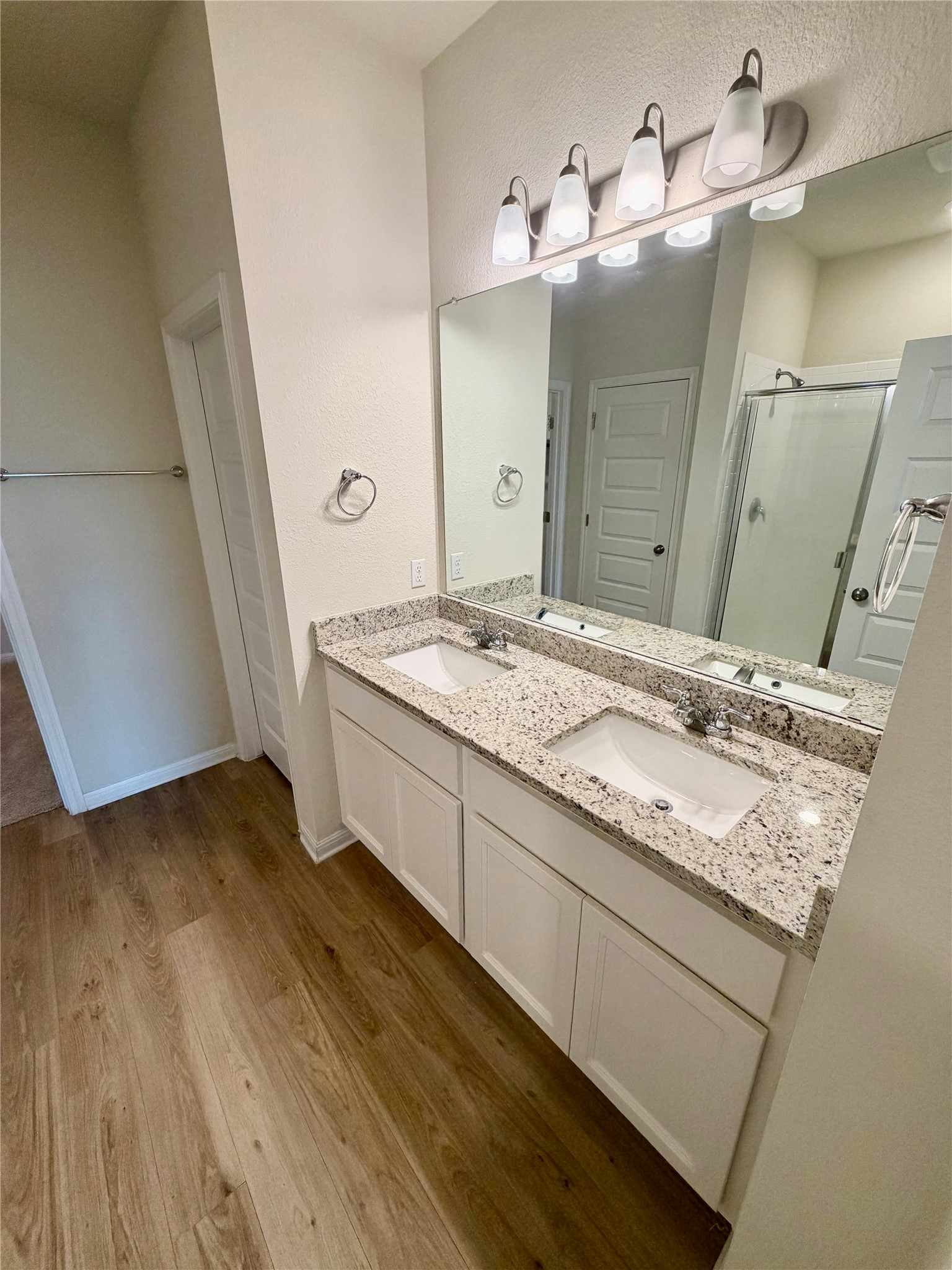 305 Tolo Drive Elgin, TX 78621 - Photo 23 of 27 Double vanity with white cabinetry, speckled countertop, and integrated sinks