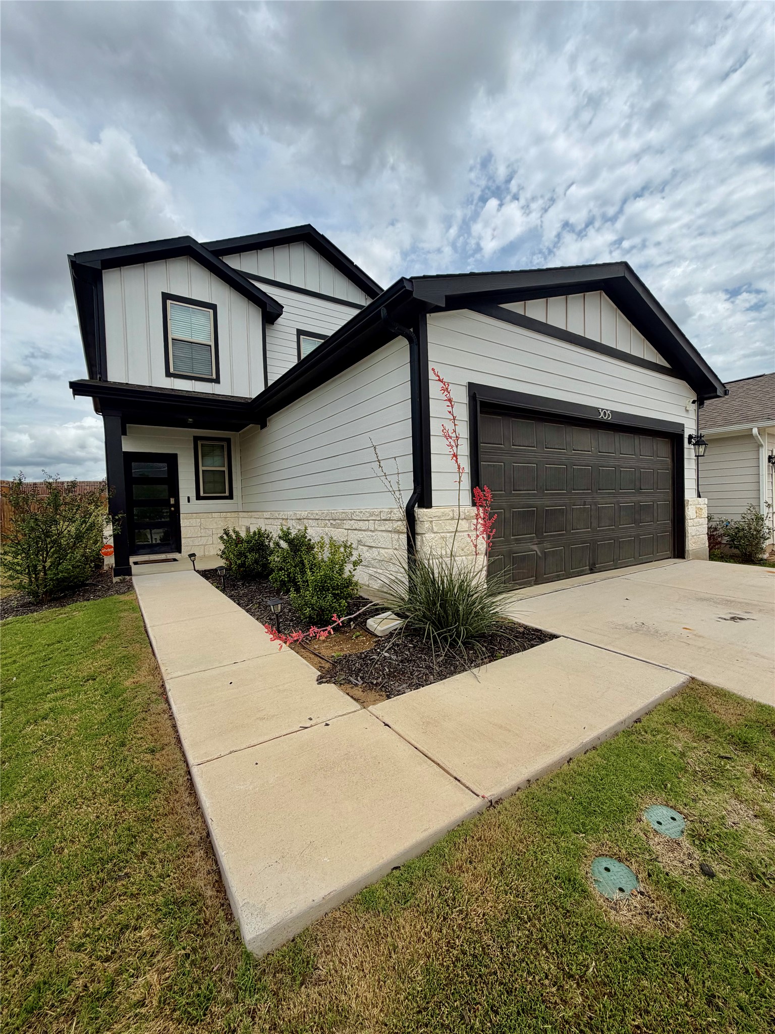 305 Tolo Drive Elgin, TX 78621 - Photo 3 of 27 Two-story residence featuring light-toned siding with dark trim accents
