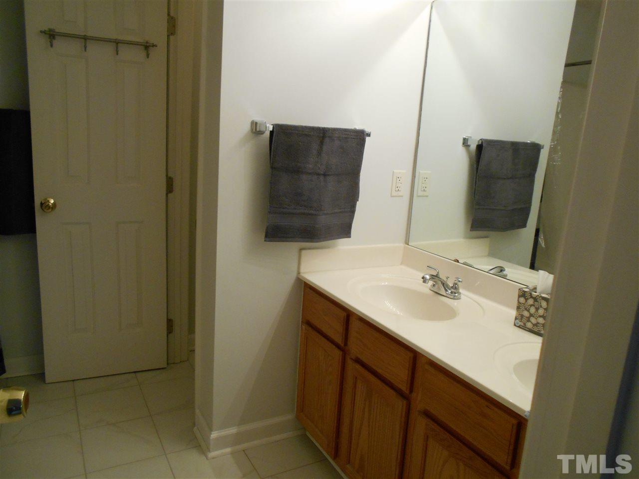 3548 Dewing Drive Raleigh, NC 27616 - Photo 7 of 12 a bathroom with a sink and a mirror