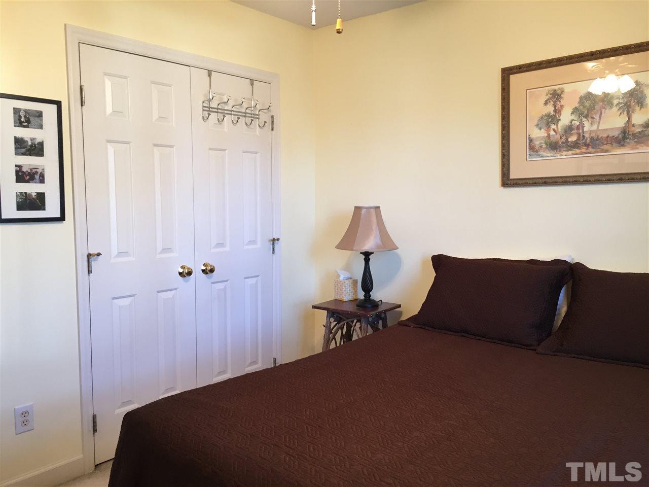 3548 Dewing Drive Raleigh, NC 27616 - Photo 9 of 12 a bedroom with a bed and a painting on the wall