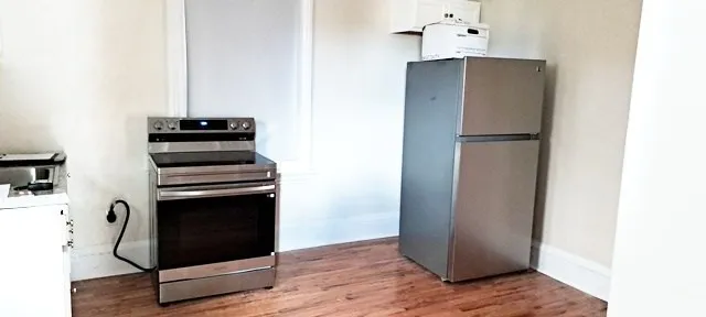 a kitchen with appliances cabinets and a window