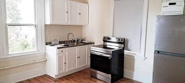 a view of a hallway with wooden floor