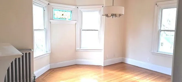a view of an entryway with wooden floor