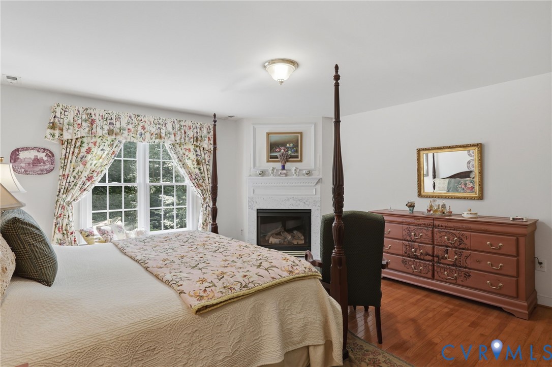 13424 Tipple Point Road Midlothian, VA 23114 - Photo 28 of 53 a bedroom with a bed and a fireplace