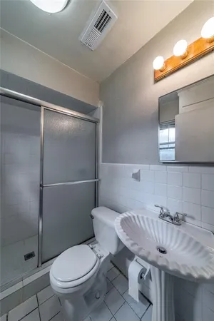 a bathroom with a granite countertop toilet sink and shower