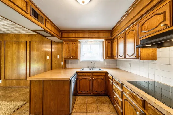 a kitchen with stainless steel appliances granite countertop a sink and cabinets