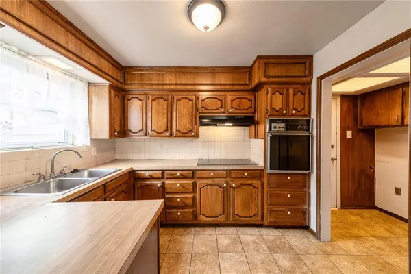 a kitchen with stainless steel appliances granite countertop a sink and a stove