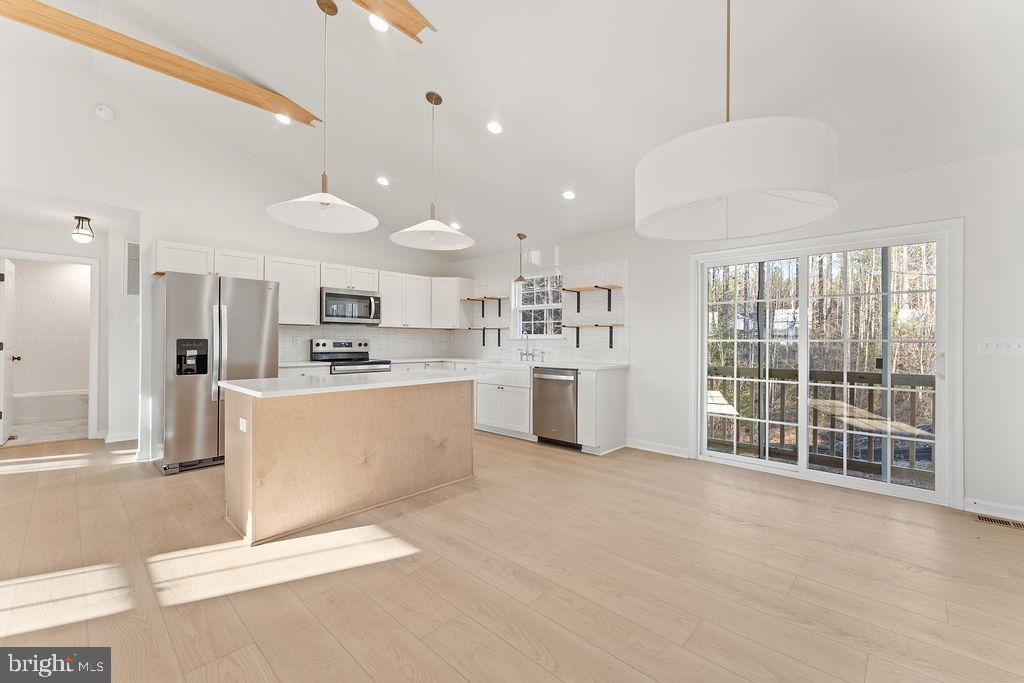 2770 Fredericks Hall Road Mineral, VA 23117 - Photo 14 of 57 a open kitchen with white cabinets and refrigerator