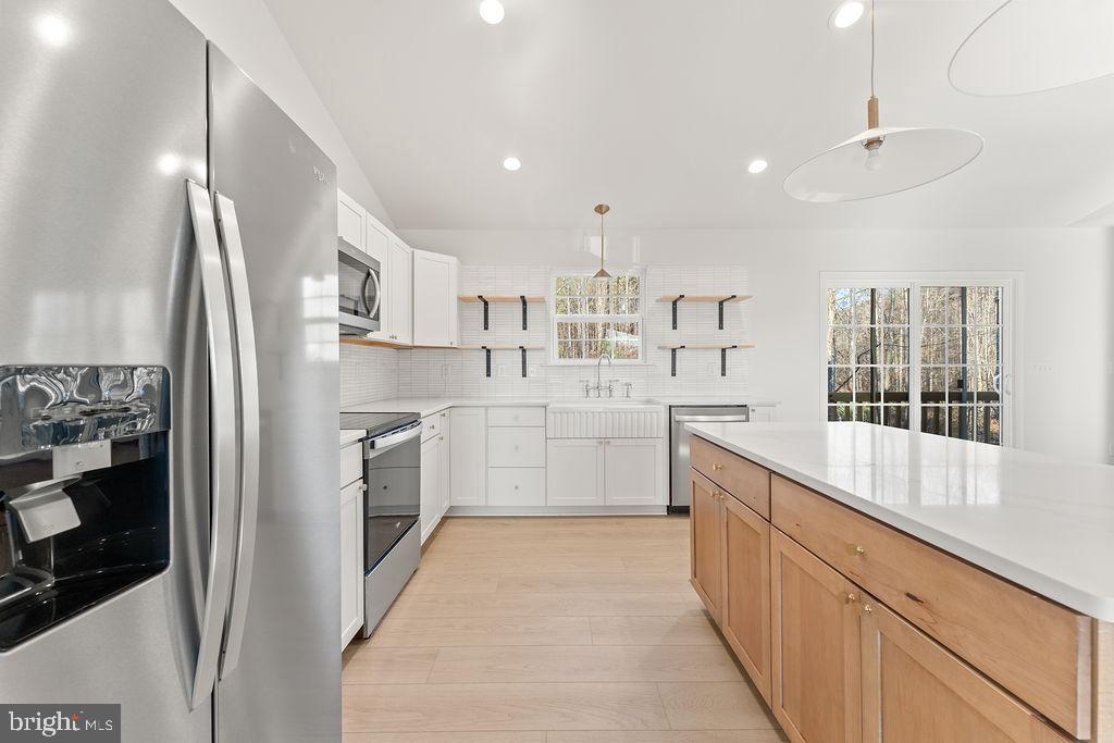2770 Fredericks Hall Road Mineral, VA 23117 - Photo 10 of 57 a kitchen with kitchen island a counter top space a sink stainless steel appliances and cabinets