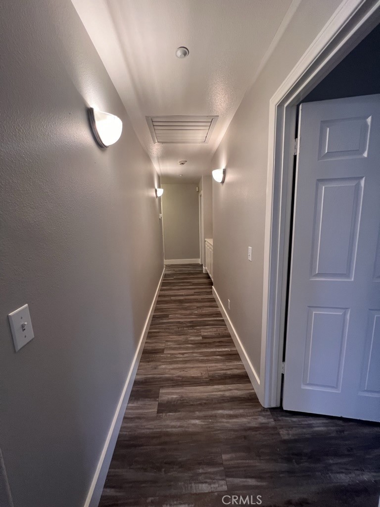 8715 Dufferin Avenue Riverside, CA 92504 - Photo 11 of 27 a view of a hallway with wooden floor and staircase