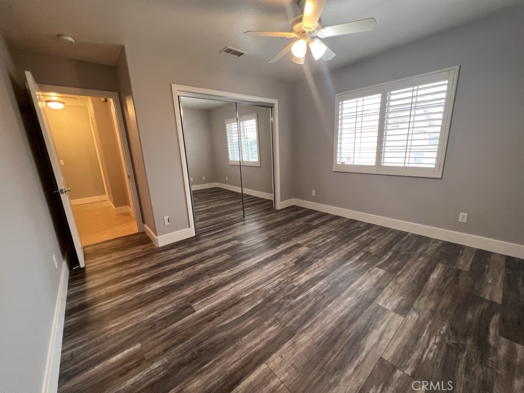 8715 Dufferin Avenue Riverside, CA 92504 - Photo 13 of 27 a view of an empty room with wooden floor and a window